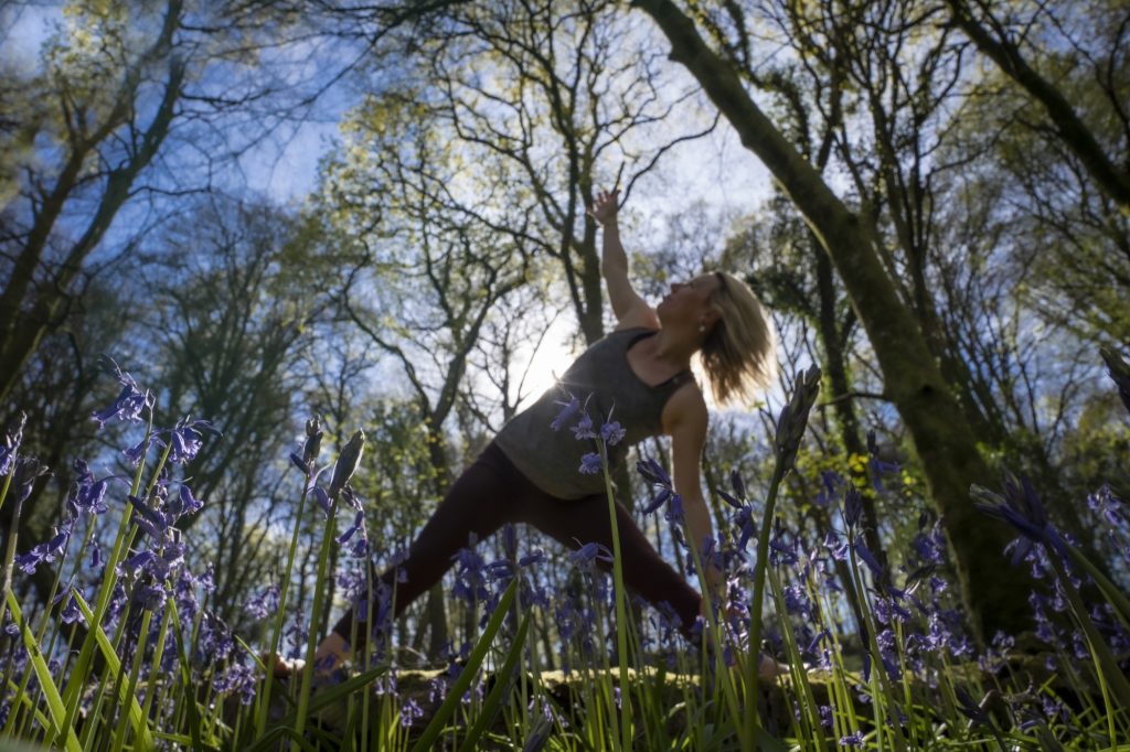 Hayley Court of Forest Retreats, practising yoga in the bluebell woods at Hill Farm, Tintern